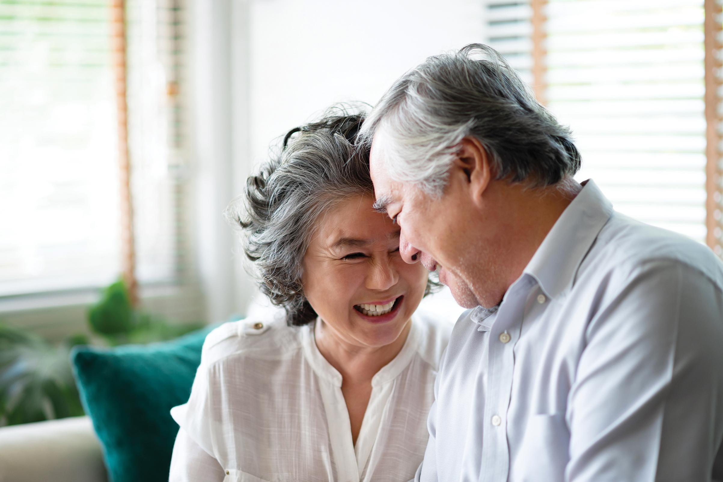 Older couple affectionately gaze at each other and smile